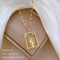 Detail of gold titanium necklace with Hamsa hand pendant and crystal accents in jewelry box - Gold Hamsa Hand Style (C425)