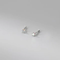 Macro shot of 999 sterling silver stud earrings with iridescent round-cut gemstones - 999 Fine Silver Pair - 2mm AB Color Zirconia