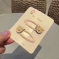 Pair of pink ribbon hair clips with glittery leopard head accents on a card - Squinting Leopard (Pair)