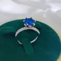 Macro detail of a 2-carat blue sapphire style ring featuring a six-prong silver setting - A1 Open Type / Blue