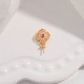 Detail of gold-plated clover pendant finding with a central purple zircon stone inlay - Style B / Gold