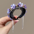 Close-up of purple flower hair clip with sparkling rhinestones and dangling tassels - Purple Flower