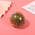 Stress relief squeeze ball with yellow eye pattern and black bead filling - 1 Piece / Orange Pulp with Black Beads