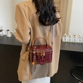 Deep burgundy box bag in glossy leather with gold hardware and tassel detail - Wine Red with Pendant