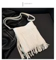 Detail showing white fringe crossbody bag with textured leather and silver hardware - White