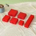 Elegant red drawer jewelry gift boxes in various sizes on soft white silk fabric - Red with Gold Foil
