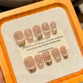 Handmade cat-eye press-on nails with golden 3D bows and champagne French tips - XS / Short Coffin