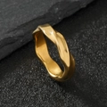 Polished wave-style stainless steel ring in golden finish on a dark stone background - US 9 / Mobius Loop / Gold