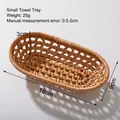 Small oval handwoven rattan towel tray with natural wicker texture and light brown finish - Rattan Oval Towel Tray Small
