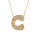 Gold letter C pendant necklace with zircon stones on thin chain over white background - Letter C / Gold