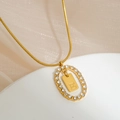 Detail of gold snake chain with oval pendant featuring pavé zircons and letter E - Letter E