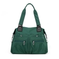 Dark green nylon tote bag with functional pockets and leather handles in a front view - Dark Green