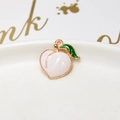 Macro shot of peach-shaped alloy pendant with pink enamel and gold-plated details - 23# White Peach