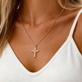 Close-up of rose gold cross necklace with clear crystals worn on a model's neck - Rose Gold DZ-1012 (Copper)