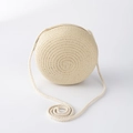 Detail of a round beige straw-woven crossbody bag for girls with a long shoulder strap - Beige Large Round Bag (15*7cm)