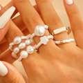 Bohemian style ring set featuring turquoise, pearls, and geometric crosses on a hand - 5-Piece Bohemian Beaded Rings (2797) / White