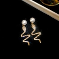 Macro detail of snake-shaped earrings with sparkling crystals and pearl studs - 19# Silver Needle-Gold Zircon Small Snake Drop