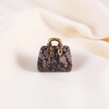 Mini handbag pendant crafted from pink rhodonite crystal with gold metal handle - Rhodonite