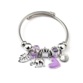 Detailed macro view of purple faceted beads, heart charm and crown pendant on woven bracelet - Shell Heart Elephant Leaf (C2-009) / Purple