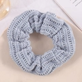 Blue knitted textured scrunchie for women shown on a beige ceramic plate in soft light - Light Gray