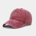 Detailed view of washed vintage red baseball cap featuring sunflower embroidery and texture - Adjustable / Burgundy