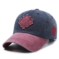Washed navy and wine red cotton baseball cap featuring maple leaf embroidery - Blue with Red Brim
