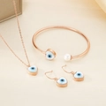 Macro shot of rose gold jewelry set featuring heart evil eye charms and a pearl accent - Heart Rose Gold 3-Piece Set (KS192836-GC)