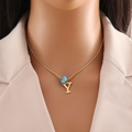Close-up of golden rope chain necklace with letter Y pendant and light blue bead on model - Letter Y (N1339)