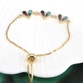 Macro detail of adjustable gold bracelet featuring three heart-shaped multi-color zircon charms - Multi-Color Rainbow (BR10803-3)