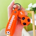 Soccer keychain with orange football charm and silicone strap featuring GOOOOOAL text - Orange