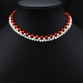 Double-layered necklace with red beads and white freshwater pearls on a black mannequin - Red Beaded Pearl Woven Necklace