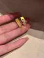 Detailed view of gold plated leaf earrings with zircon tassels held in hand - Tassel Stud Earrings (Silver Pin - Gold) / Gold