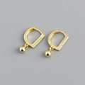 Close-up of gold hoop earrings with small cubic zirconia inlays and ball pendants - D-shaped Hoop Earrings (S-E1556) / Gold