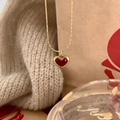 Elegant gold titanium chain necklace with a glossy red heart pendant on a soft knit background - Red Enamel Heart (891)