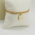 Golden layered paperclip chain bracelet featuring a letter A pendant with white shell inlay - Style A