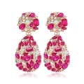 Vintage oversized gold alloy teardrop earrings with pink and clear crystals on white background - Clip-on Earrings / Rose Red