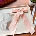 Light pink satin double bow hair clip with long ribbons in an elegant flat lay setting - Light Peach Red 121