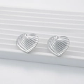 Silver heart stud earrings with ripple texture on white display stand in 18K gold style - Heart Ripple / Silver