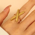 Macro shot of gold-plated X-shaped ring on model's finger with smooth metallic finish - 18KC Gold X-Shape Design Ring (N-919)
