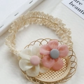 Lace baby headband with pink and white fabric flowers on a woven basket - Pink and Off-white
