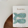 Close-up of sparkling sequined mermaid tail hair clips with blue and green fish scale texture - Green