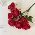 Realistic bundle of seven red artificial roses with green leaves in a clear glass vase - Red