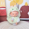 Labubu plush doll accessory wearing a soft green monster costume on a woven mat - Green Baby Dinosaur / First And Second Generation Keychains Are Compatible With La Cloth Dolls. Dolls Not Included.