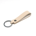 Minimalist beige PU leather keychain with a polished metal ring and rivet detail - Khaki & Silver