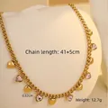 Detalle del collar de colgante de corazón dorado con cristales rosas y eslabones gruesos - Corazón / Rosa