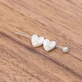 White heart-shaped shell bead with golden letter X on a metal pin for DIY jewelry - Letter X