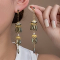New Chinese style dark green beaded tassel earrings with gold finish on model - E5640-5/Gold Base Dark Green Tassel
