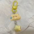 Close-up of cute yellow cloud keychain with star pendant on white wrinkled paper - Yellow Expression Cloud Star / Yellow