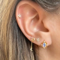 Macro shot of woman wearing gold star moon earrings set with rainbow cubic zirconia - Earring Set (TZ00007)