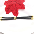 Detail of 18k gold plated Tree of Life pendant on adjustable black braided rope bracelet - Gray